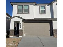 Inviting two-story home featuring a neutral color palette, a two-car garage, and a charming covered entry at 9815 S 11Th St, Phoenix, AZ 85042