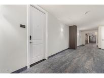 Bright condo hallway with a unit door, painted in neutral tones with modern flooring at 1 E Lexington Ave # 1108, Phoenix, AZ 85012