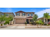 Charming two-story home with a neutral color palette, attached garage, and professionally landscaped front yard at 10224 E Talameer Ave, Mesa, AZ 85212