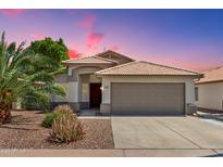 Charming single-story home featuring desert landscaping, a tile roof, and a spacious two-car garage at 1057 W Laurel Ave, Gilbert, AZ 85233