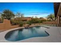 Beautiful pool with waterfall feature and mountain views, perfect for relaxing outdoors at 24645 N 117Th St, Scottsdale, AZ 85255