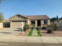 Charming single story home featuring a manicured front yard, desert landscaping and a two car garage at 3555 E Feather Ave, Gilbert, AZ 85234