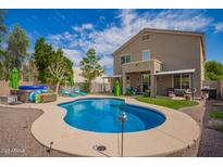 Backyard pool features a baja step and inground hot tub with lounge seating, plus a covered patio off the main house at 3960 W Salter Dr, Glendale, AZ 85308