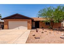 Charming single-story brick home with a well-kept yard and attached garage at 4420 E Covina St, Mesa, AZ 85205