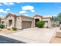 Charming single-story home with a well-maintained front yard, two car garage and inviting curb appeal on a sunny day at 4748 E Eden Dr, Cave Creek, AZ 85331