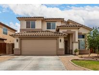 Inviting two-story home featuring a neutral color palette, tile roof, attached garage and low maintenance landscaping at 6637 W Watkins St, Phoenix, AZ 85043