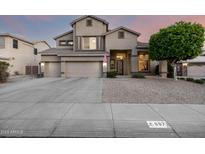 Stunning two-story home with a three-car garage and well-manicured front yard at 6971 W El Cortez Pl, Peoria, AZ 85383
