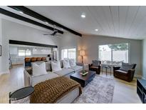 Bright living room featuring a comfortable sofa, stylish decor, and an open layout into the kitchen at 7524 N Via Del Elemental --, Scottsdale, AZ 85258
