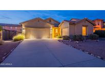 Charming single-story home with a well-lit driveway and attached three-car garage at 7606 E Globemallow Ln, Gold Canyon, AZ 85118
