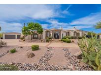 An estate home with desert landscaping and a circular drive with a detached garage at 8502 E Santa Catalina Dr, Scottsdale, AZ 85255