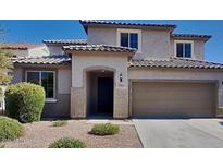 Charming two-story home with a well-manicured front yard and neutral-toned stucco, complemented by a two-car garage at 984 W Belmont Red Trl, San Tan Valley, AZ 85143