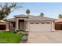 Charming single-story home with a well-manicured lawn, desert landscaping, and a two-car garage at 10280 N 94Th Dr, Peoria, AZ 85345