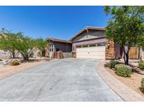 Charming single-story home with a two-car garage and a beautifully paved driveway at 12035 S 186Th Ave, Goodyear, AZ 85338