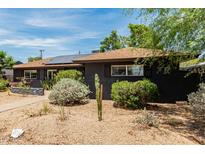 Charming home featuring xeriscape landscaping, solar panels, and a well-maintained exterior at 1814 W Thomas Rd, Phoenix, AZ 85015