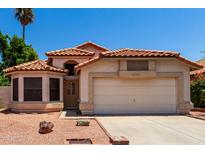 Charming single-story home with desert landscaping, tile roof, and a two-car garage at 18899 N 77Th Ave, Glendale, AZ 85308