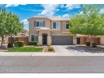 Inviting two-story home featuring a landscaped front yard and a two-car garage in a residential area at 2185 E Gillcrest Rd, Gilbert, AZ 85298