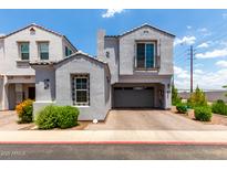 Charming gray two-story home with a two-car garage and beautifully landscaped front yard at 286 E Raleigh Dr, Chandler, AZ 85286