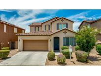 Charming two-story home featuring a well-manicured lawn, a two-car garage, and decorative shutters at 322 N 78Th Pl, Mesa, AZ 85207