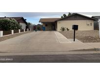 Charming single-story home with a long driveway and low-maintenance desert landscaping at 3229 W Cholla St, Phoenix, AZ 85029
