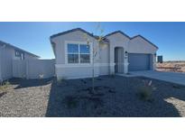 Charming single-story home featuring a modern gray exterior, a two-car garage, and a xeriscaped front yard at 48402 N Duran Way, Gold Canyon, AZ 85118