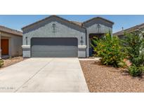 Charming single-story home featuring a well-manicured front yard and two-car garage at 5240 E Gummite Dr, San Tan Valley, AZ 85143