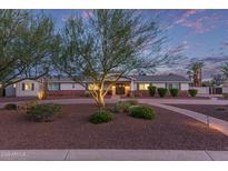 Charming single-story home featuring a well-manicured front yard and walkway under a picturesque sky at 6231 E Desert Cove Ave, Scottsdale, AZ 85254