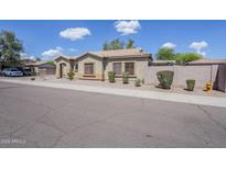 Charming one-story home boasts a low-maintenance front yard and desert landscaping under a clear, sunny sky at 6317 S Kimberlee Way, Chandler, AZ 85249