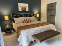 Bedroom with a queen bed, stylish headboard, accent wall and a walk in closet at 9451 E Becker Ln # 1051, Scottsdale, AZ 85260