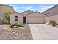 Well-maintained single-story home featuring a two-car garage and low-maintenance desert landscaping at 973 E Kelsi Ave, San Tan Valley, AZ 85140