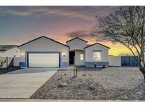 Charming single-story home featuring desert landscaping and a spacious two-car garage at 14178 S Diablo Rd, Arizona City, AZ 85123