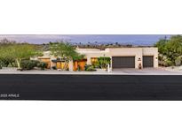 An exterior front view of a charming single-story home with a two-car garage and desert landscaping at 15816 E Eagle Crest Rd, Fountain Hills, AZ 85268