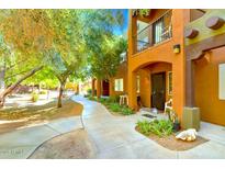 Inviting two-story condo with walkway and landscaping, with balcony and neutral desert color palette at 1718 W Colter St # 126, Phoenix, AZ 85015