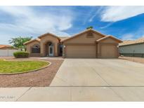 Inviting single-story home featuring a three-car garage and low-maintenance desert landscaping at 2189 E Ranch Ct, Gilbert, AZ 85296