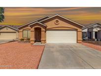 Inviting single-story home with a two-car garage and desert landscaping at 22615 N 31St Dr, Phoenix, AZ 85027