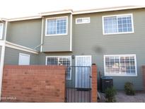 Inviting exterior of a two-story home with fresh paint and a secure gated front entrance at 2301 E University Dr # 334, Mesa, AZ 85213
