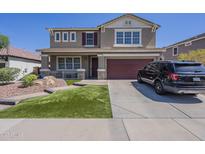 Beautiful two-story home with a well-manicured lawn and attached two-car garage at 29474 W Columbus Ave, Buckeye, AZ 85396