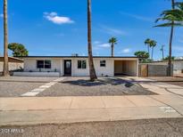 Charming single-story home with a well-manicured front yard and covered parking at 3650 E Laurel Ln, Phoenix, AZ 85028