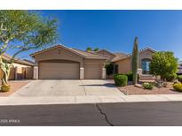 Charming single-Gathering home featuring desert landscaping, three-car garage, and a neutral color palette at 4241 E Andre Ave, Gilbert, AZ 85298
