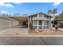 Charming home featuring desert landscaping, a covered carport, and an inviting exterior at 5735 E Mcdowell Rd # 147, Mesa, AZ 85215