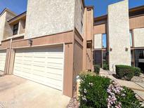 Inviting townhome with a two-car garage, fresh landscaping, and a cozy entrance, offering both convenience and curb appeal at 6533 N 10Th Pl, Phoenix, AZ 85014