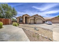 Charming single-story home featuring a two-car garage, neutral stucco, and low maintenance desert landscaping at 863 S Del Rancho --, Mesa, AZ 85208