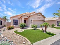 Charming single-story home featuring well-manicured landscaping and a welcoming entrance at 11547 W King Snake Ct, Surprise, AZ 85378
