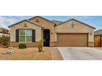 Charming single-story home with a well-maintained front yard and a two-car garage at 13612 W Desert Moon Way, Peoria, AZ 85383