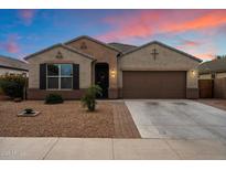 Charming single-story home with a desert landscape, two-car garage and covered entry at 13612 W Desert Moon Way, Peoria, AZ 85383