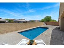 Private backyard pool with lounge chairs, perfect for relaxing and enjoying sunny days at 13612 W Desert Moon Way, Peoria, AZ 85383
