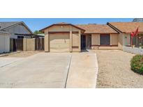 Charming single-story home with a desert landscape and a long driveway at 20644 N 30Th Dr, Phoenix, AZ 85027
