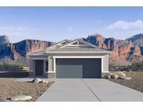 Charming single-story home featuring a gray color scheme, two-car garage, and beautiful mountain views at 2067 W Sheridan Ave, Apache Junction, AZ 85120