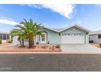 Beautiful home exterior with desert landscaping and charming blue vinyl siding at 215 N Power Rd # 33, Mesa, AZ 85205