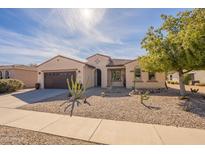 Charming single-story home with a two-car garage, desert landscaping, and a tile roof in a sunny setting at 2599 E San Mateo Dr, Casa Grande, AZ 85194