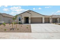 Inviting single-story home with a neutral color palette, desert landscaping, and a two-car garage at 2640 W Stanton Ave, Apache Junction, AZ 85120